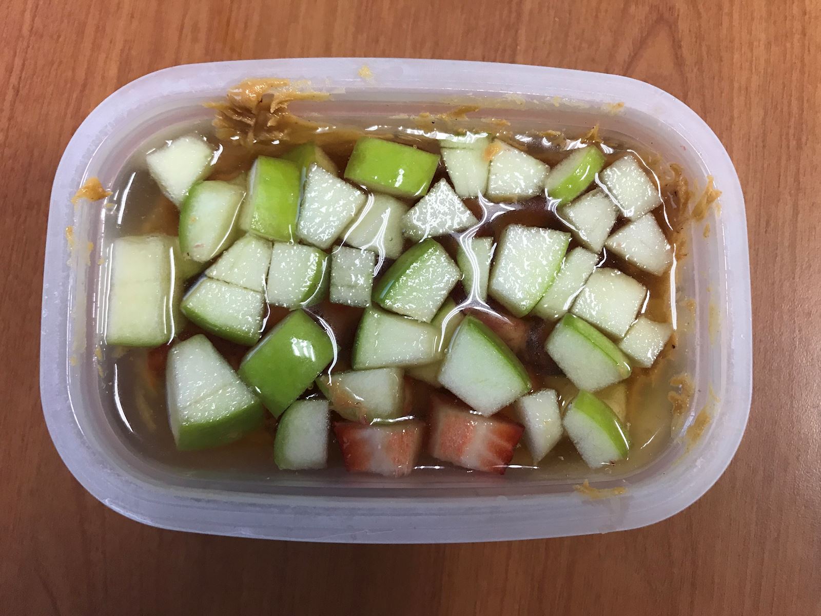 apples and strawberries in tupperware