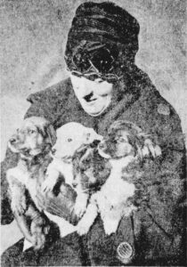 1927 woman holding puppies